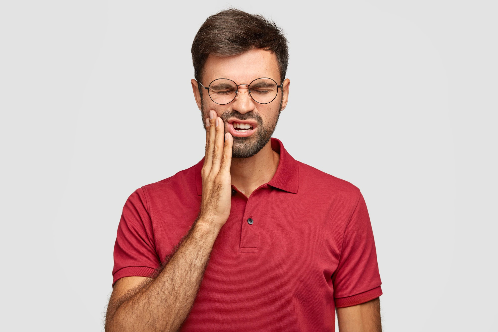 Man holding mouth in pain